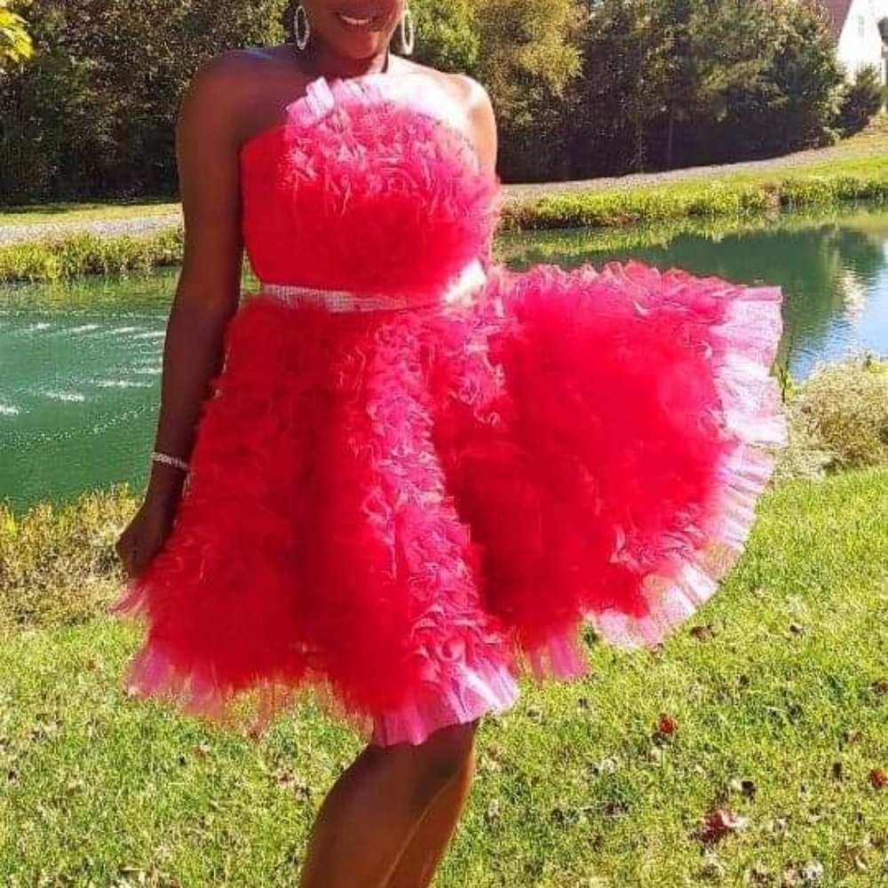 Red and pink strapless mini dress with silver belt.